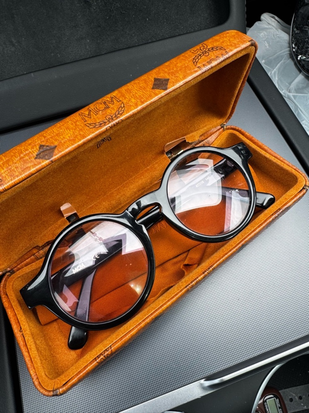 MCM Black Round eyeglasses with logo on frame arms. Very light purple tint. Rx